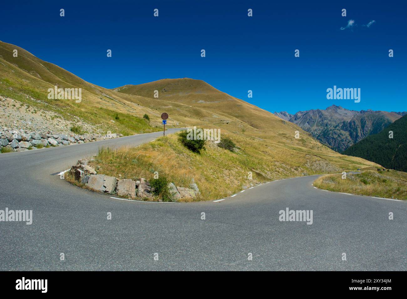 Winding mountain road with curves in alps Stock Photo
