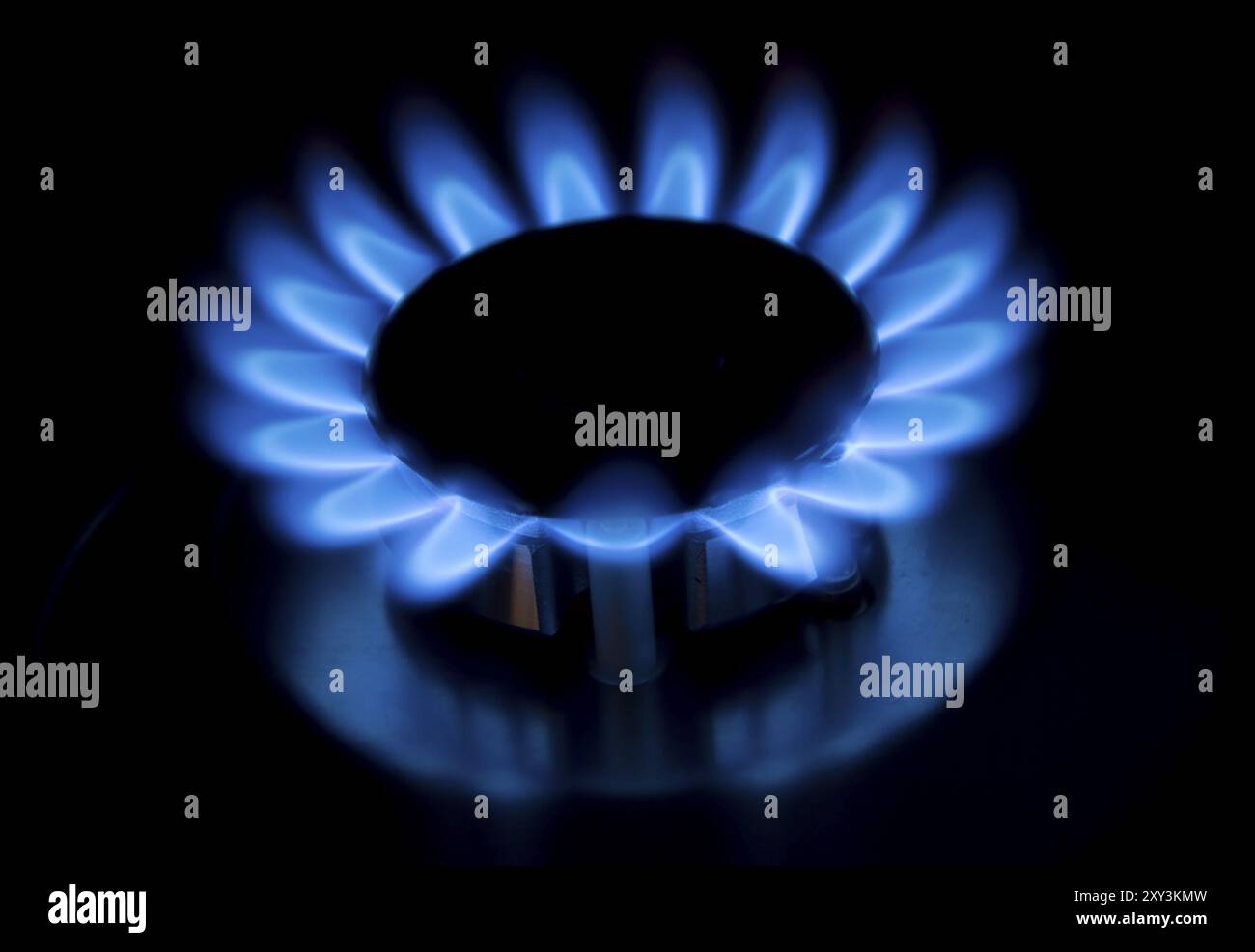Blue gas flames of a burner with black background Stock Photo - Alamy