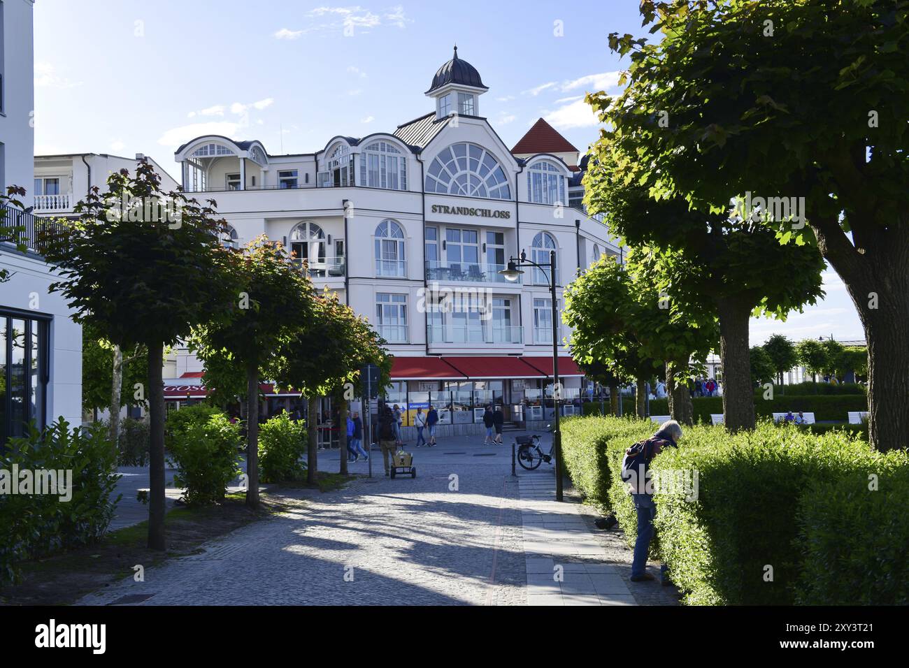 lively-beach-promenade-with-elegant-white-buildings-and-green-areas-on