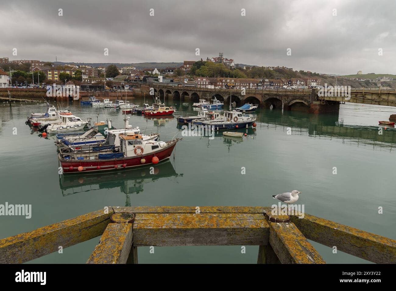 Folkestone, Kent, England, UK, October 29, 2016: Boats in Folkestone Harbour with the old Railway Bridge in the background Stock Photo