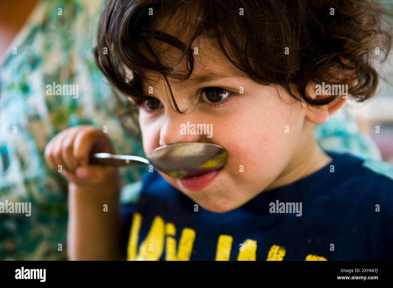 Infant Using Spoon Toddler holding spoon hi-res stock photography and images - Alamy