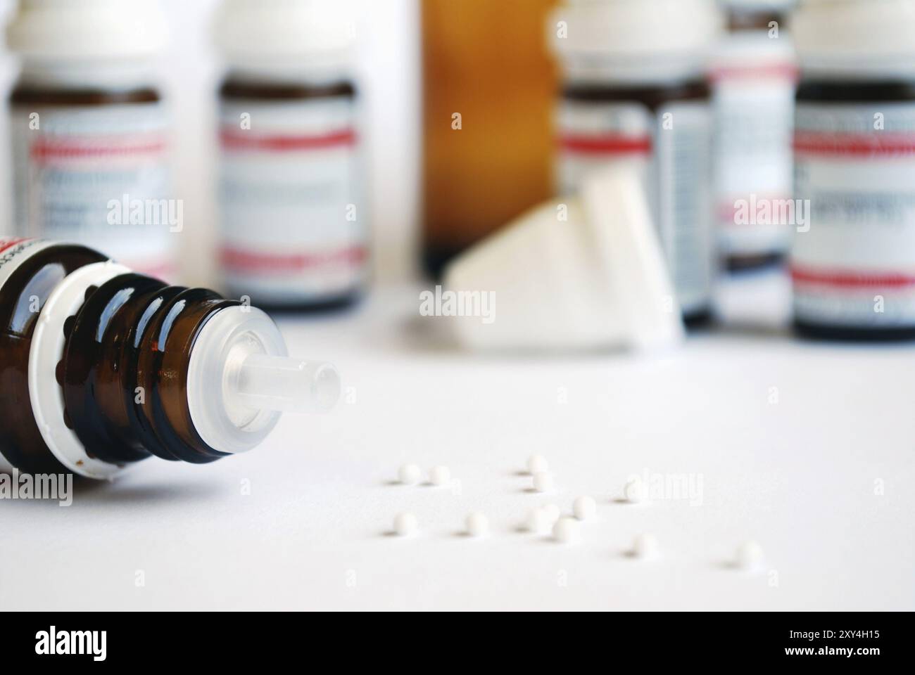 Closeup of homeopathic, globule in front of bottles Stock Photo