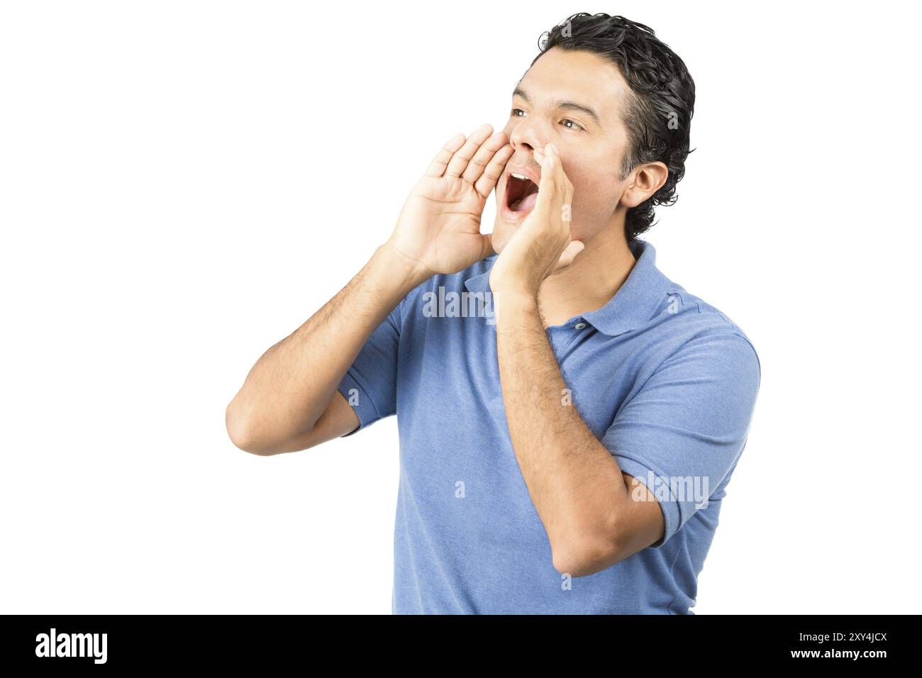 Profile of good looking latino male in casual blue shirt looking up and away to the side cupping his hands around his mouth to shout, scream, announce Stock Photo