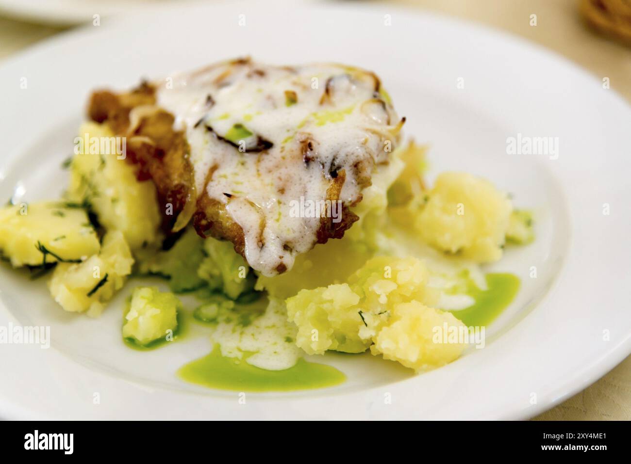 Boiled potatoes and cod in a batter Stock Photo - Alamy