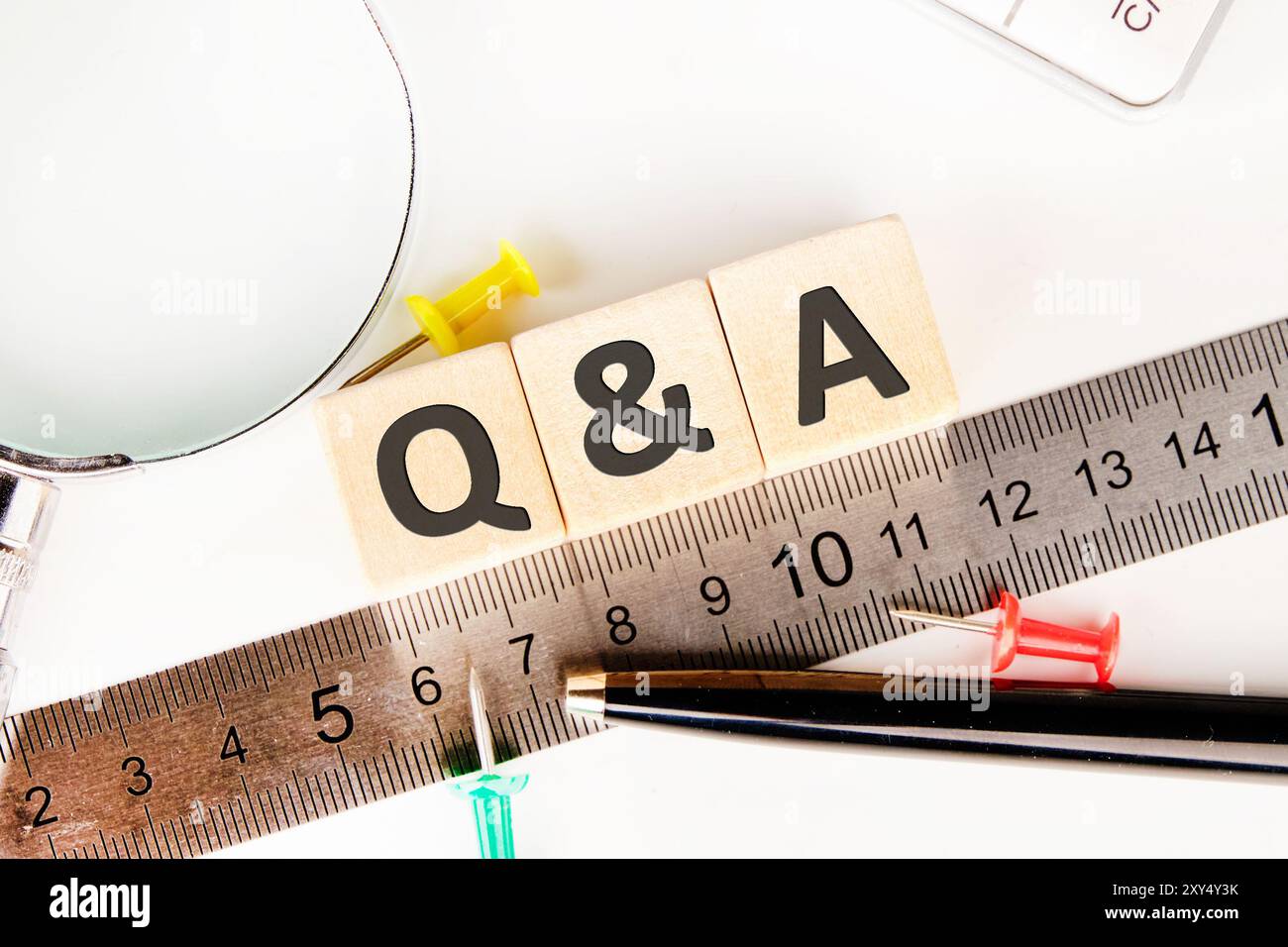 Q and A questions and answers symbol. Concept words Q and A on wooden cubes next to the measuring ruler Stock Photo