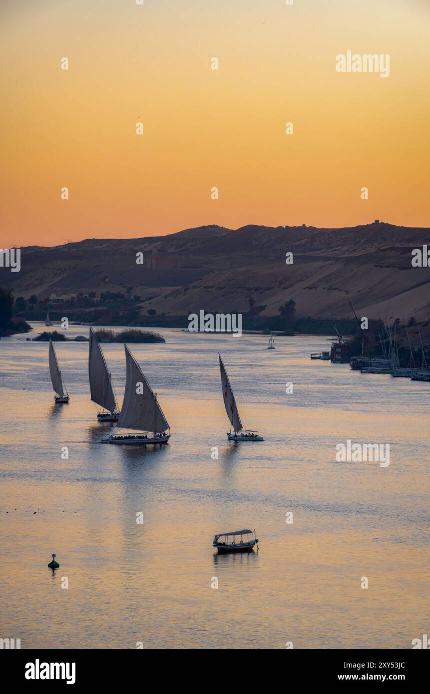 Sunset over the Nile in Aswan with felucca boats, Egypt. February 2023 Stock Photo