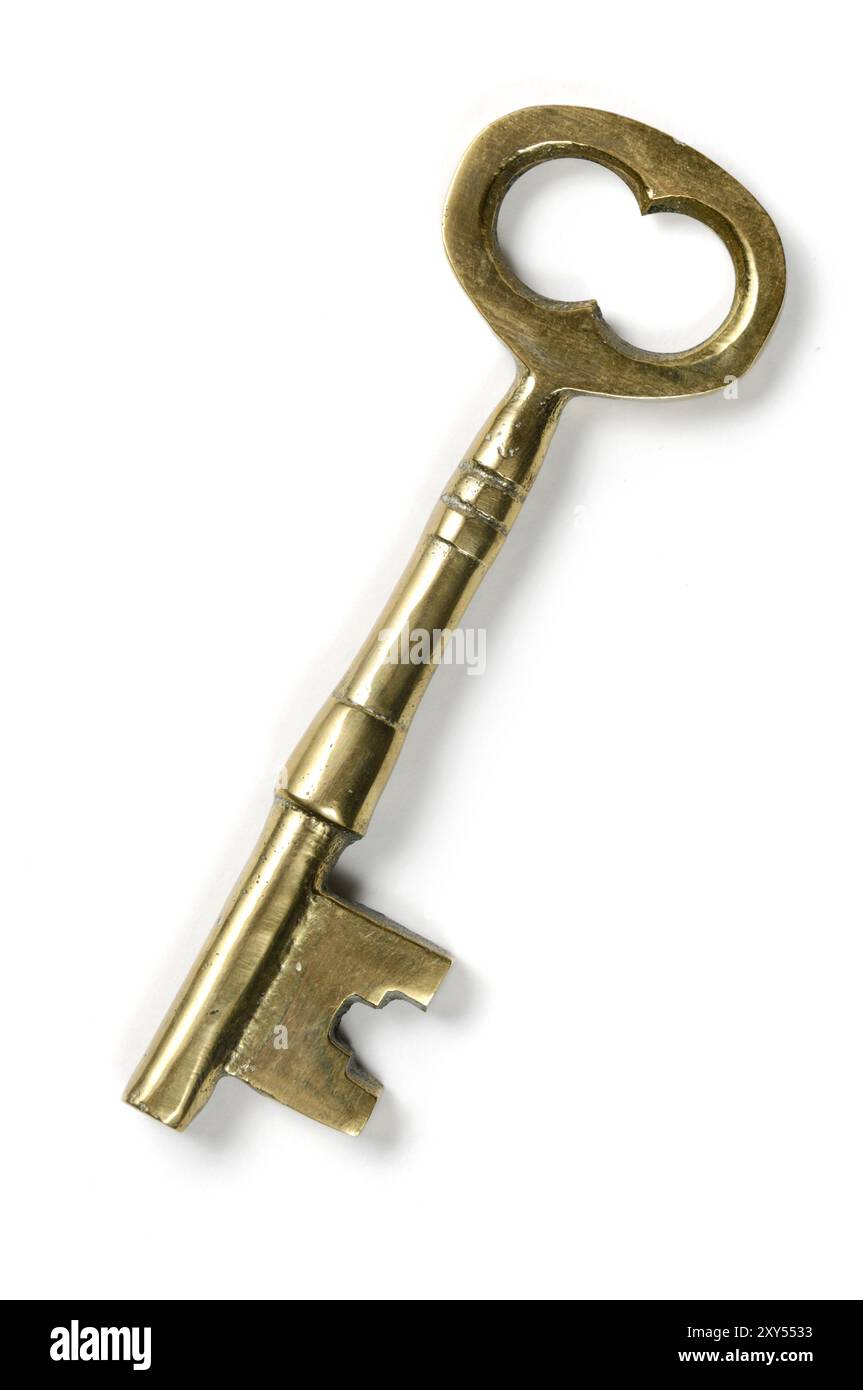 Old brass shiny skeleton keys isolated on white background Stock Photo