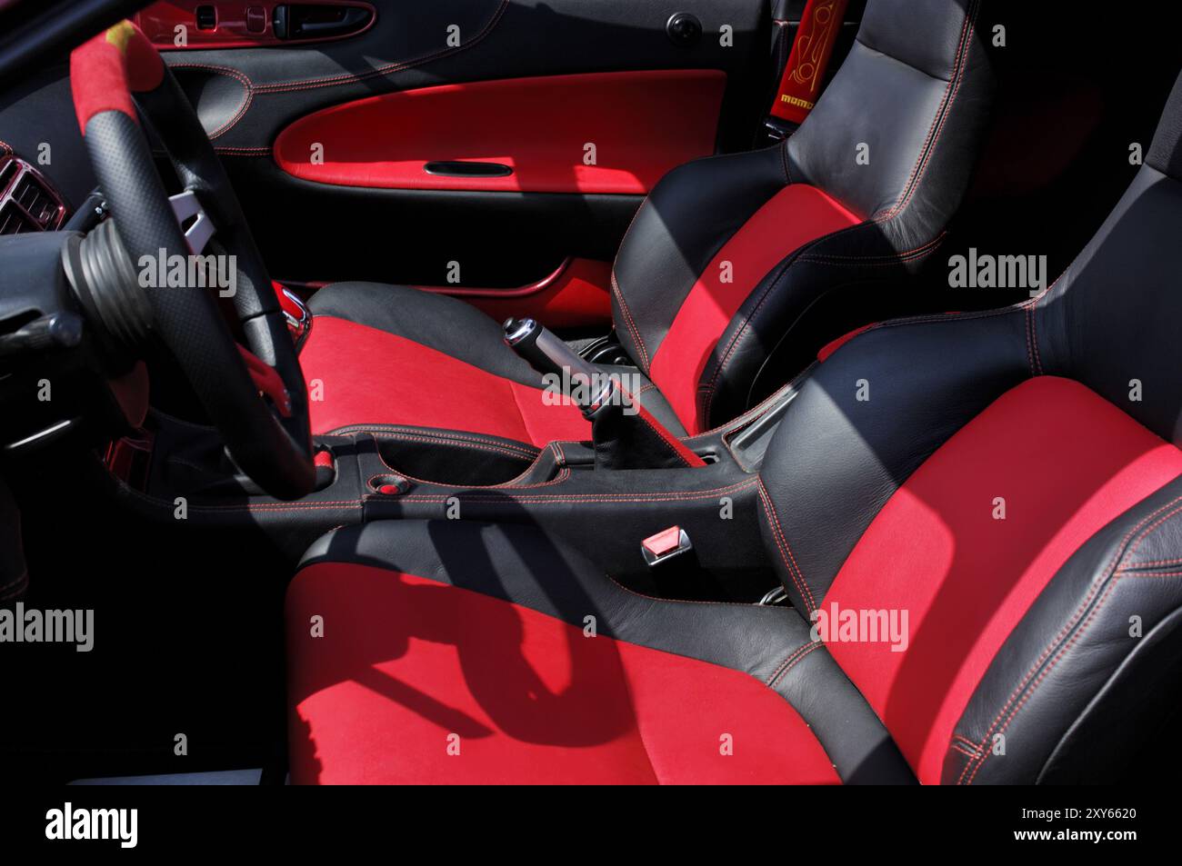 Red and black leather interior of a custom sports race car with ...
