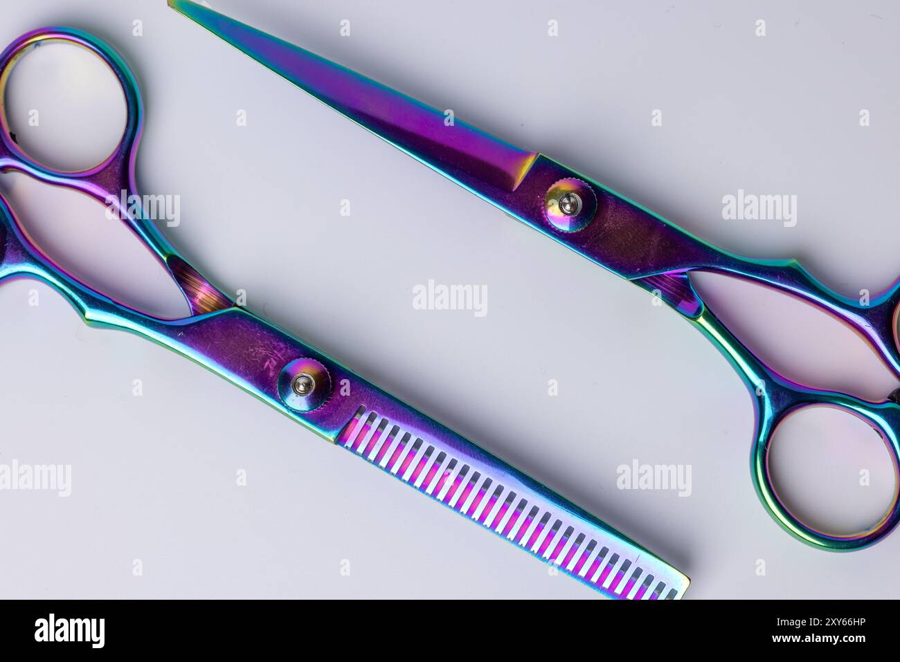 A detailed top-down view of two barber scissors angled towards each ...