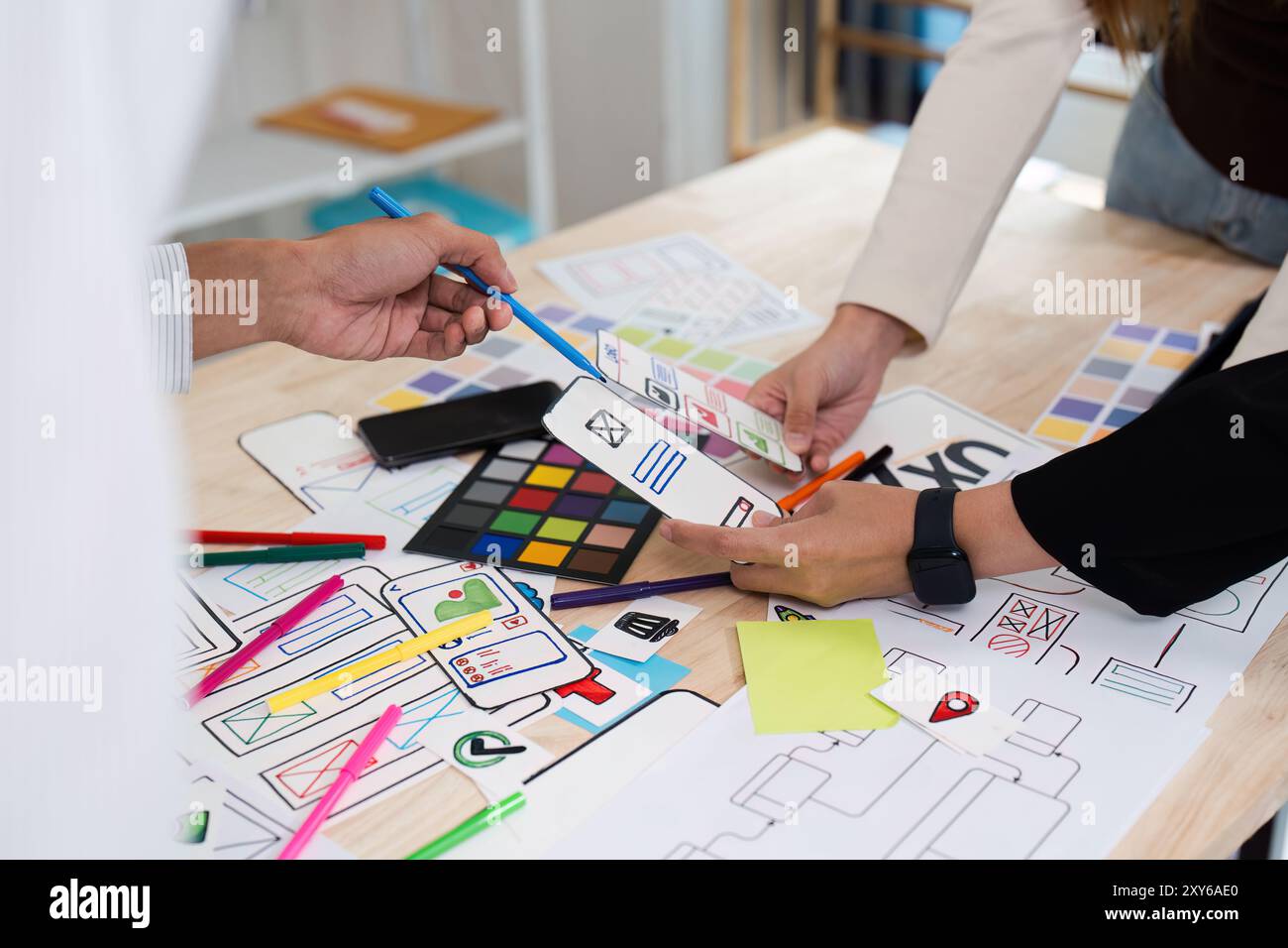 Creative Team Collaborating on UX UI Design with Colorful Prototypes ...