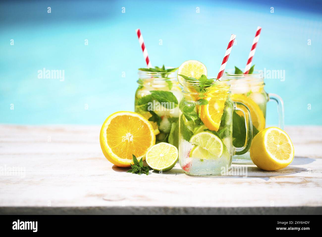 View of Glasses of citrus lemonade near pool. Summer pool party Stock Photo - Alamy