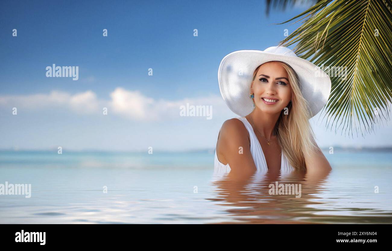 An attractive young woman in a sun hat on the beach swimming in the sea ...