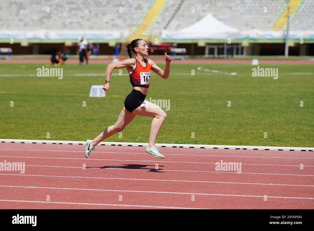 IZMIR, TURKIYE - MAY 25, 2024: Undefined athlete running during Balkan Athletics Championships in Izmir Ataturk Stadium Stock Photo