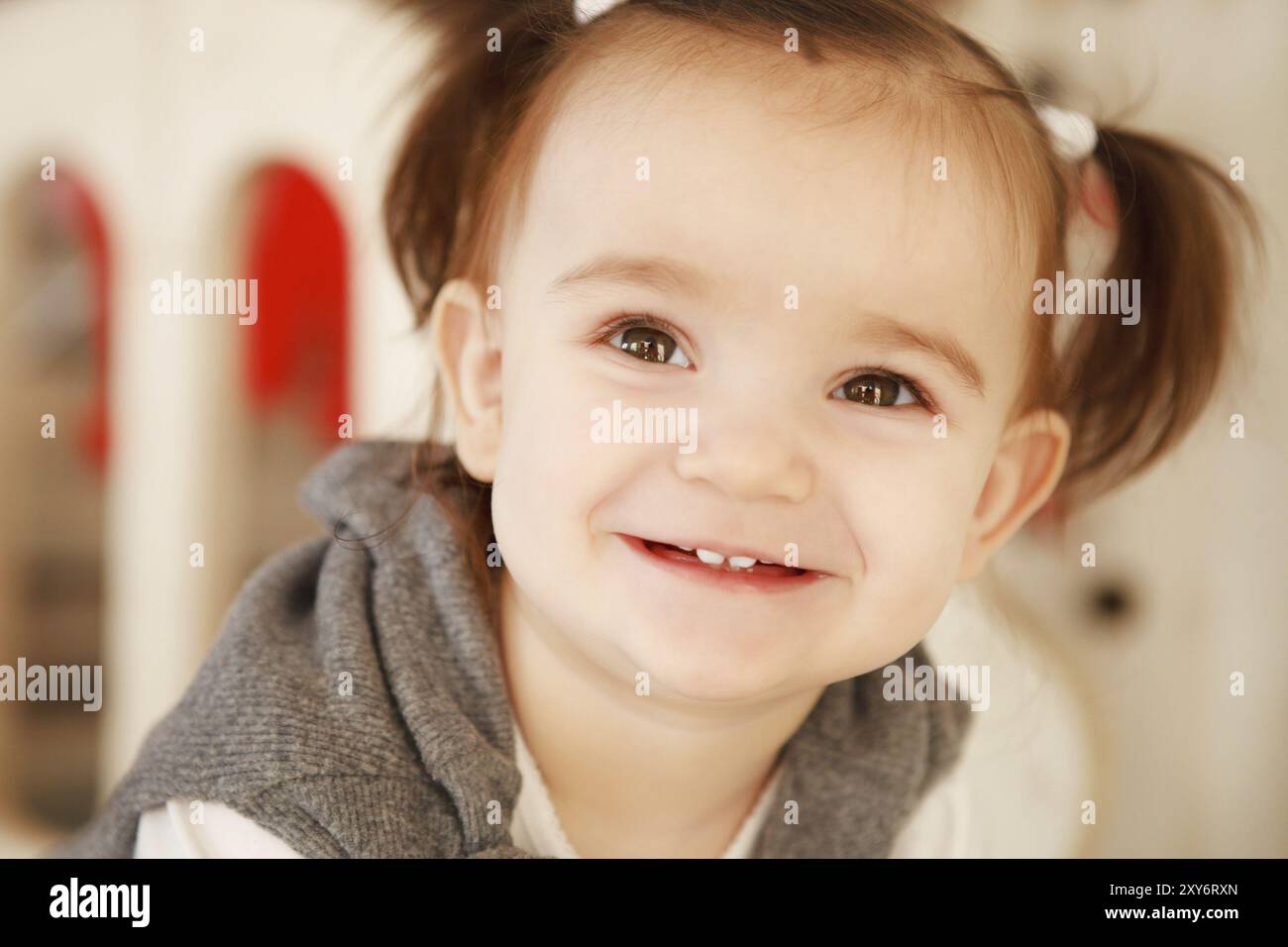 Close up portrait of a smiling baby girl indoor Stock Photo