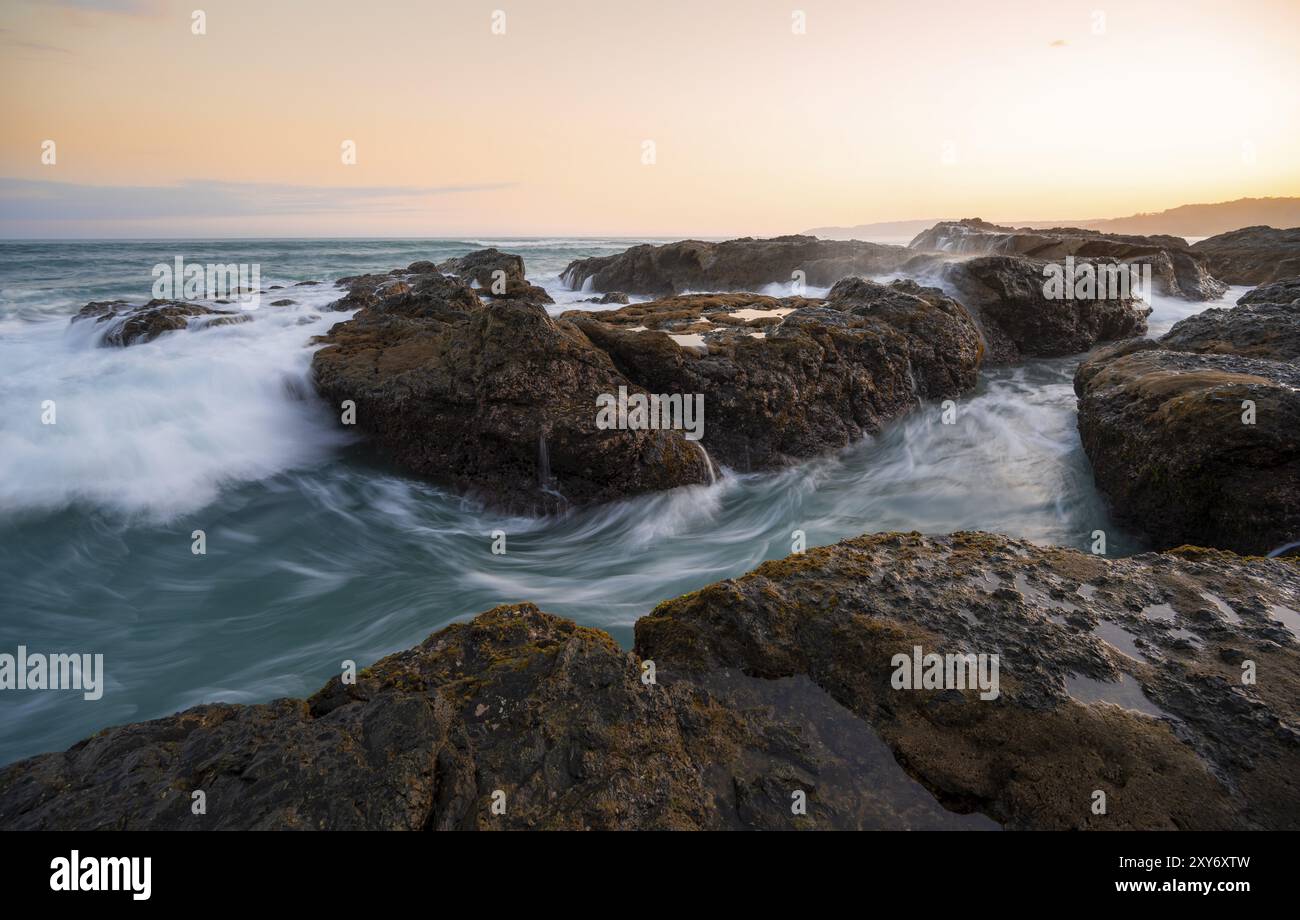 Waves washing over rocks by the sea, long exposure, coastal landscape ...