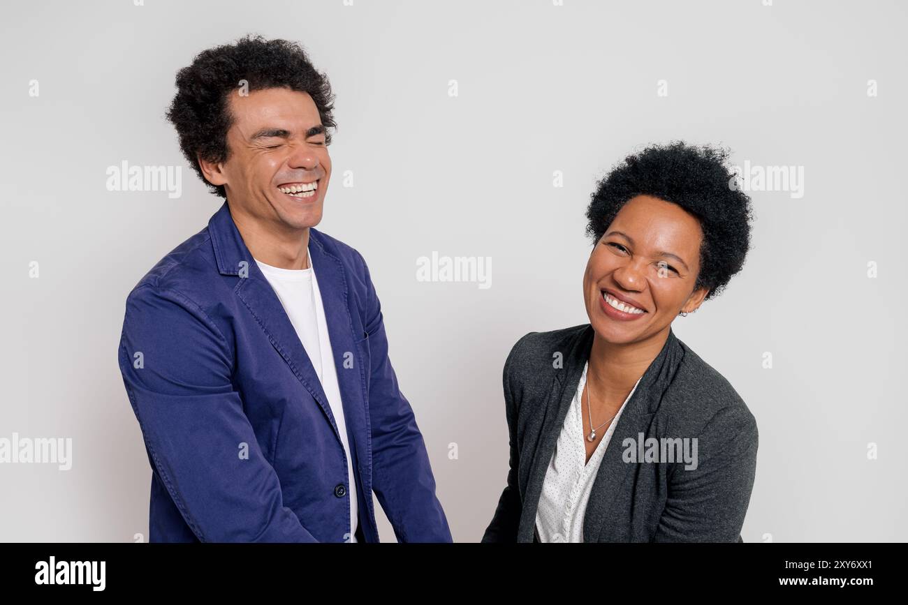 Portrait of male and female professionals smiling cheerfully while standing on white background Stock Photo