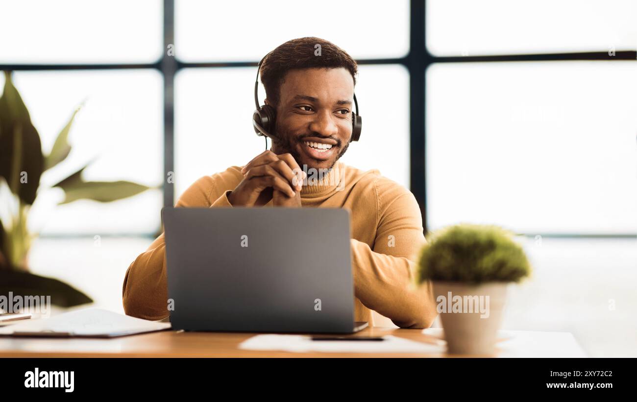 Happy afro manager working in call centre Stock Photo