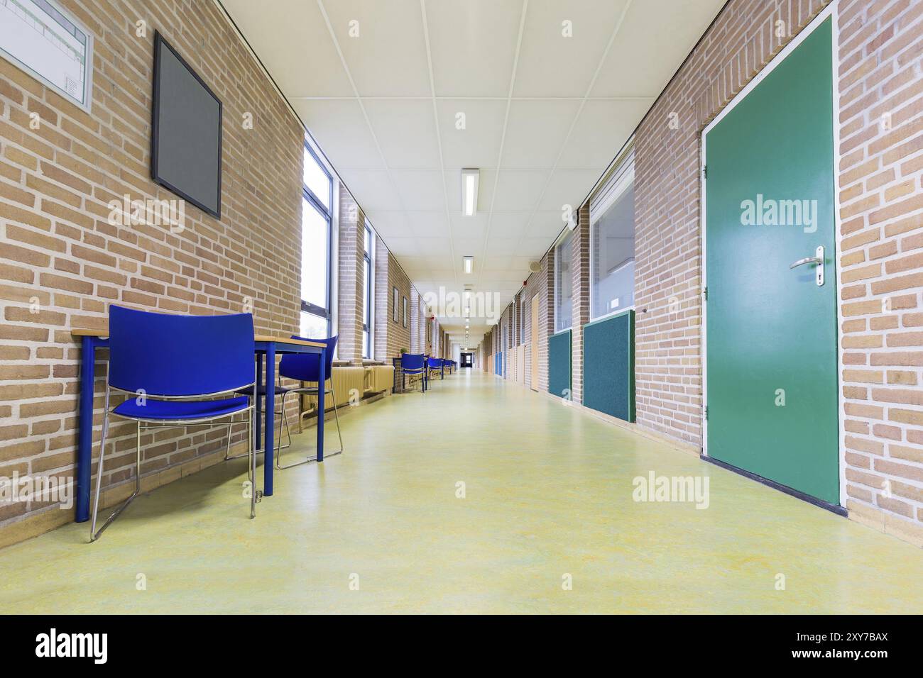 Straight long and abandoned corridor in high school Stock Photo