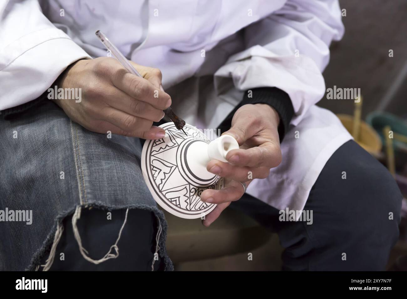 Potters painting vessels in a pottery Stock Photo - Alamy