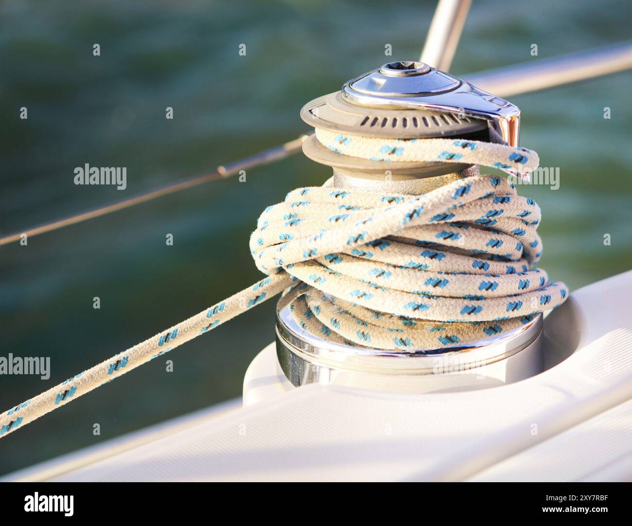 Sailboat detailed parts. Close up on winch and rope of yacht over blue ...
