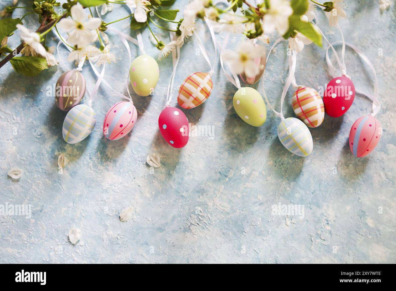 Easter background with Easter eggs and spring flowers. Top view with copy space Stock Photo