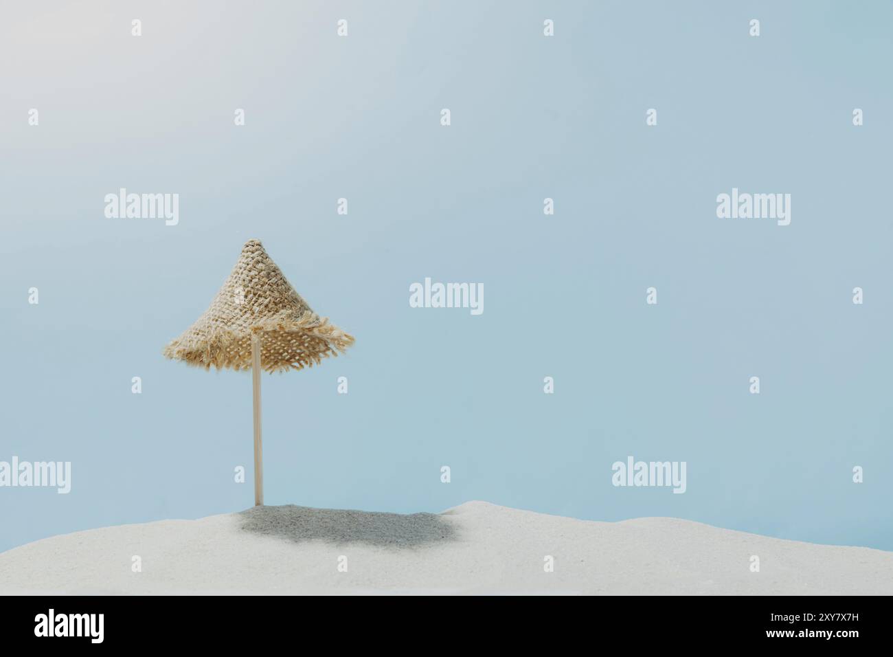 Vacation, beach, travel, relaxation concept. Symbolic background with beach sand, mini sun lounger, blue sky, clouds, sea or ocean. Minimalism with co Stock Photo