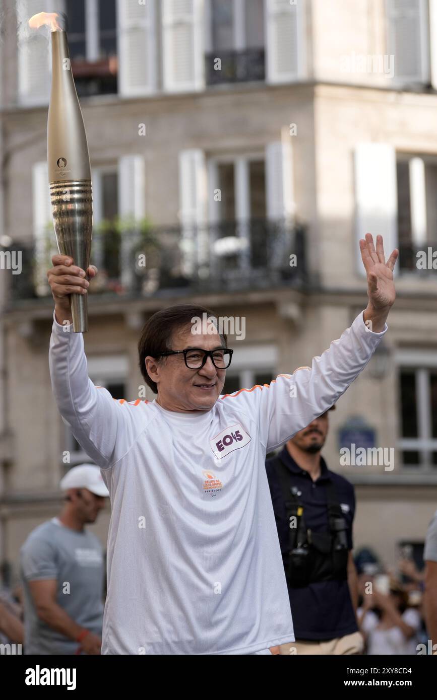 Jackie Chan carries the Paralympic torch Wednesday, Aug. 28, 2024 in