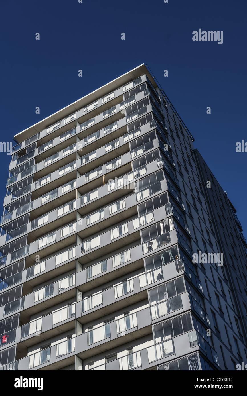 High rise apartment building against blue sky Stock Photo - Alamy - High-Rise Apartment With High Ceilings And Natural Light