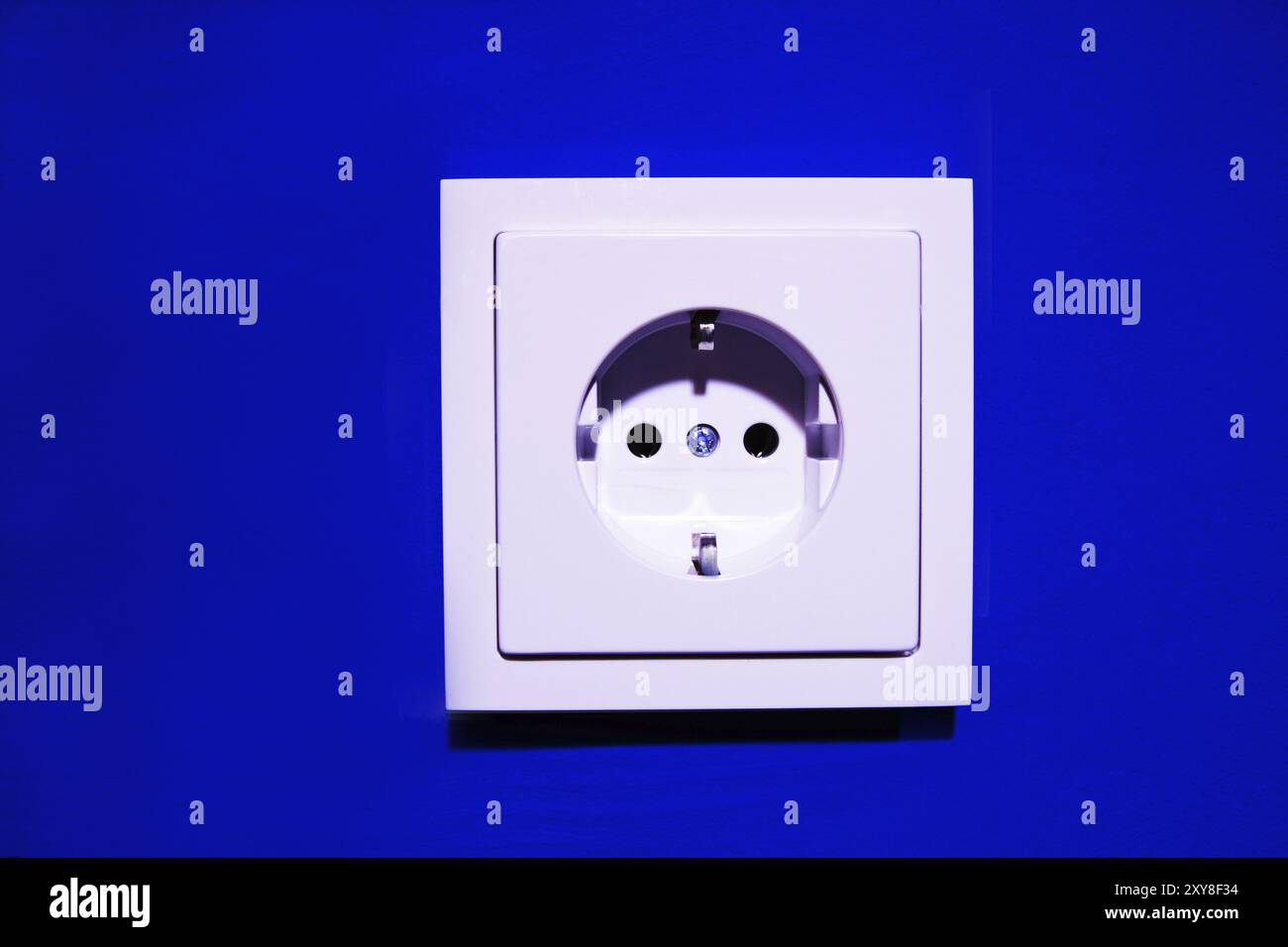 New socket on blue-painted wall Stock Photo