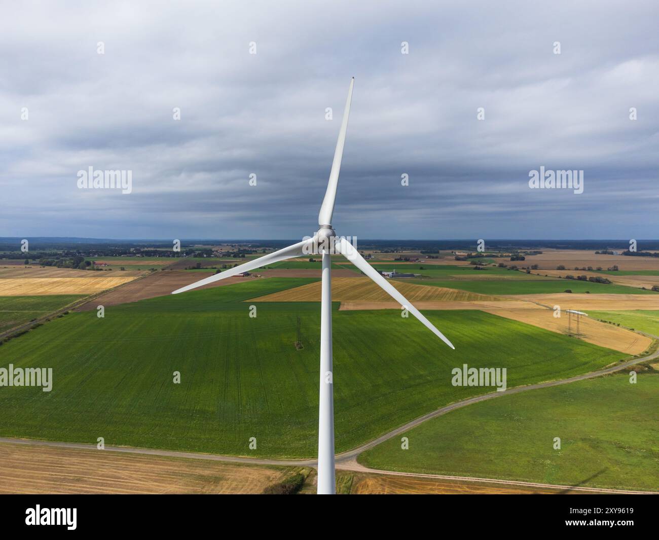 Aerial front view of a wind turbine in the wind. Sweden, summer, green ...