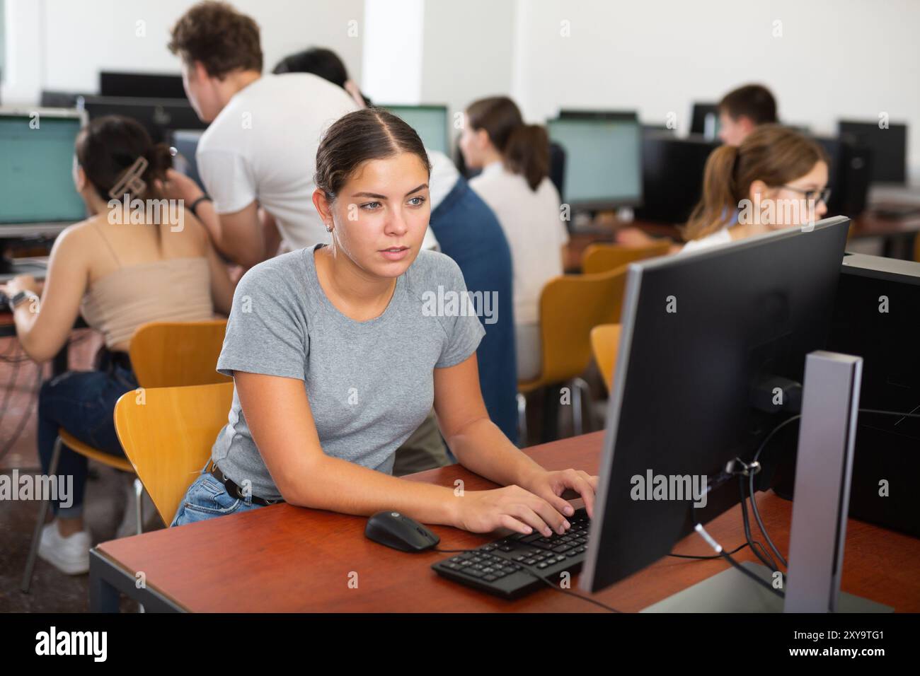 Woman learning to use software in computer class Stock Photo