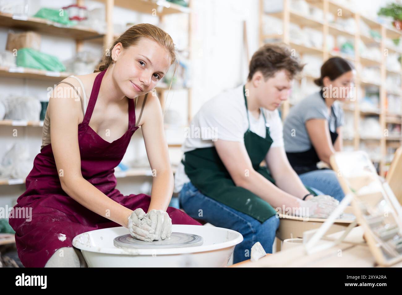 Girl teenager learns how to create pottery in workshop Stock Photo - Alamy