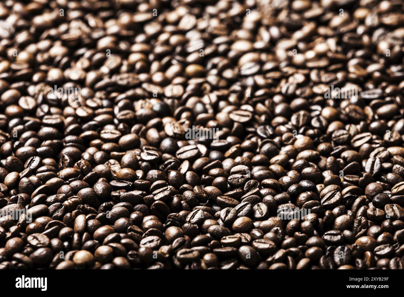 Brown roasted raw coffee bean heap background Stock Photo - Alamy