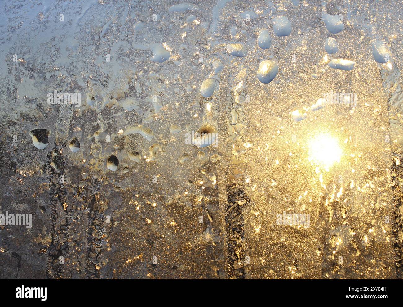 Frosty natural pattern and sun on winter glass Stock Photo - Alamy