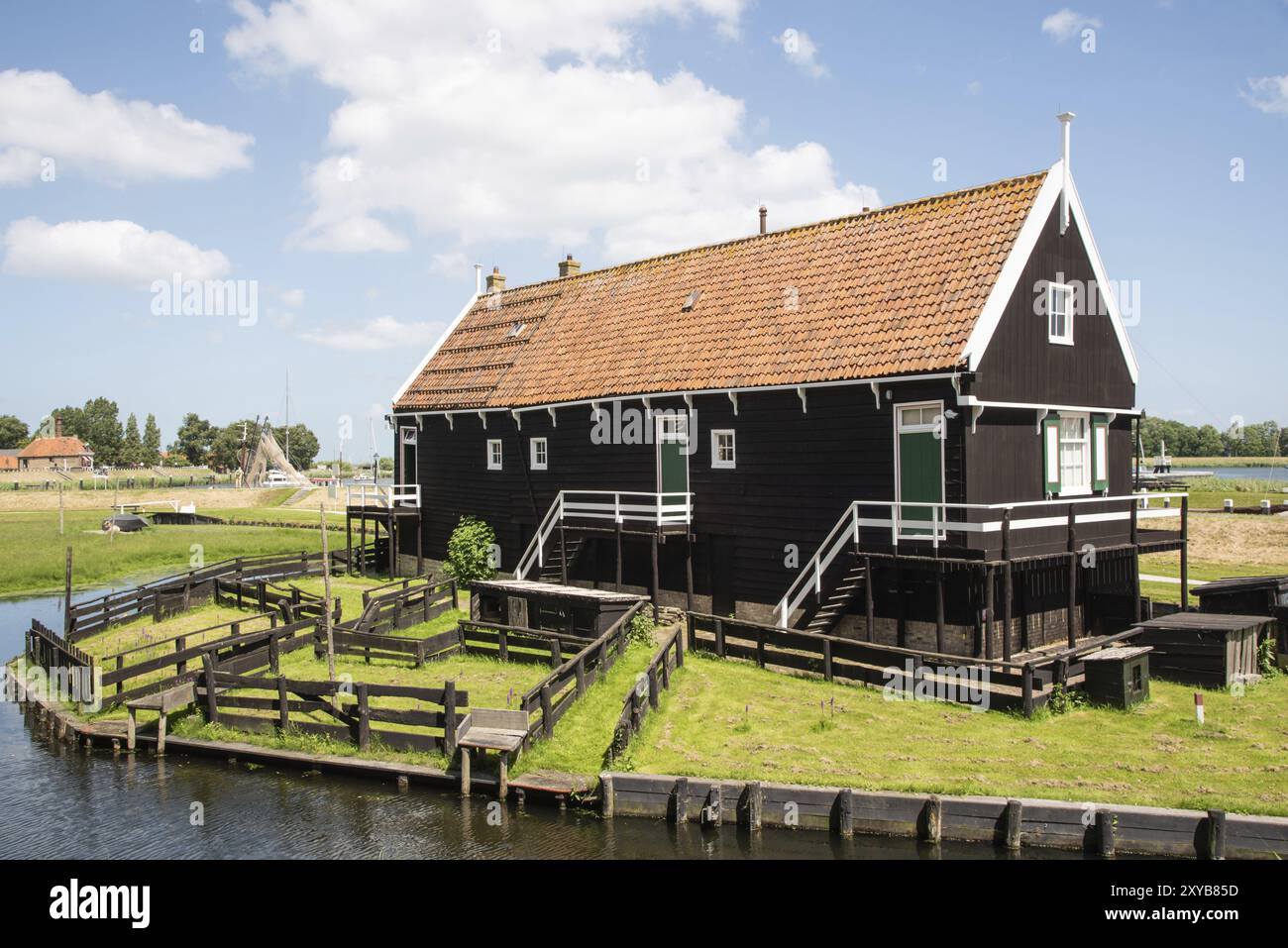 Enkhuizen, Netherlands. June 2022. Fisherman's cottage at the harbour with traditional fishing boats in Enkhuizen Stock Photo