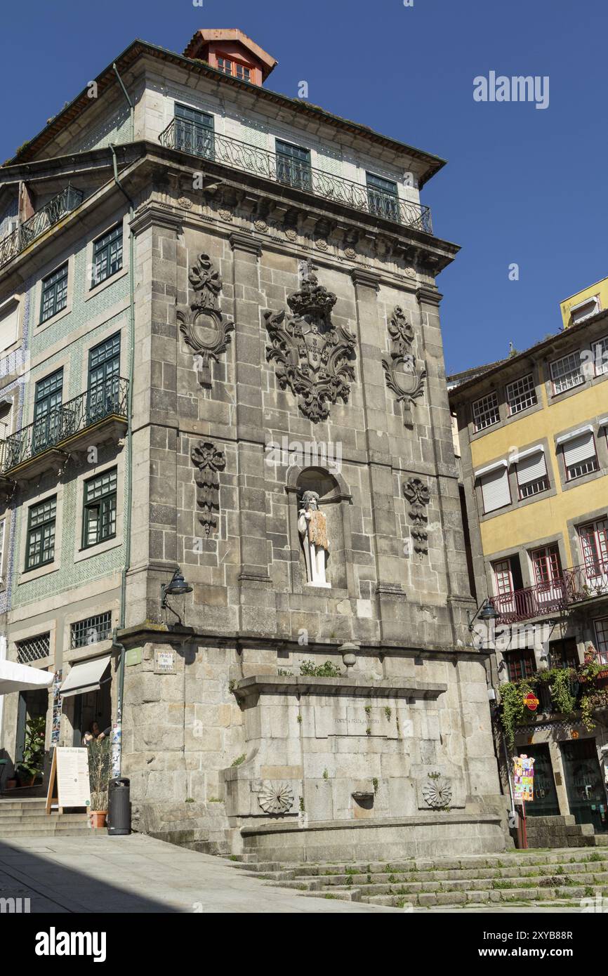 Historic house facade with fountain and St John the Baptist, statue by ...