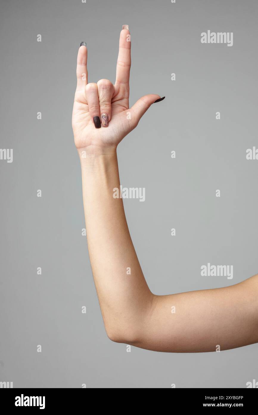 Woman's Hand Making Rock And Roll Sign With Black Nail Polish Stock ...