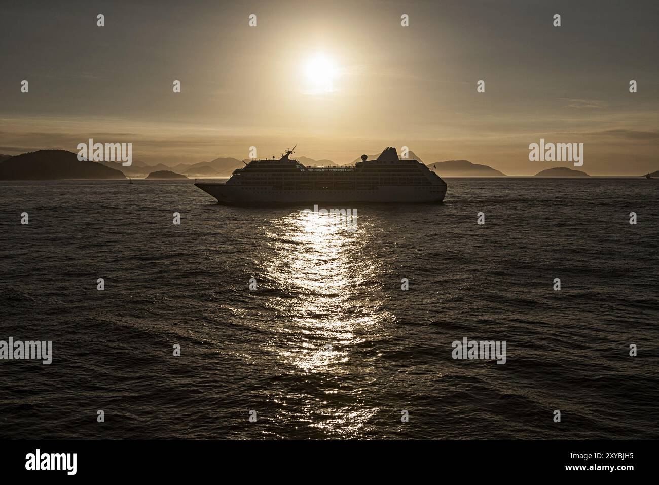 Cruise ship at sunset in backlight Stock Photo - Alamy