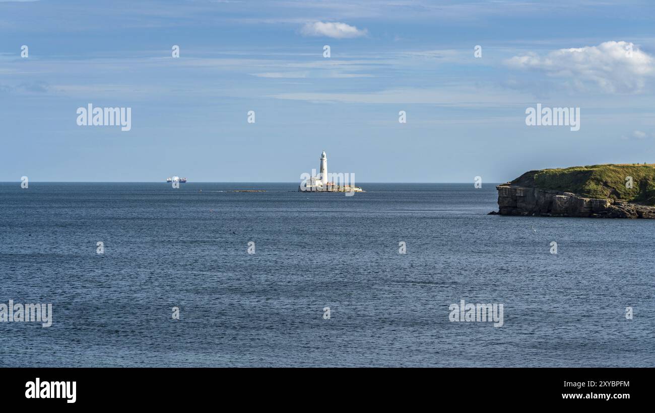 North Sea coast in Collywell Bay, Seaton Sluice in Northumberland, England, UK, with St. Mary's Lighthouse in the background Stock Photo