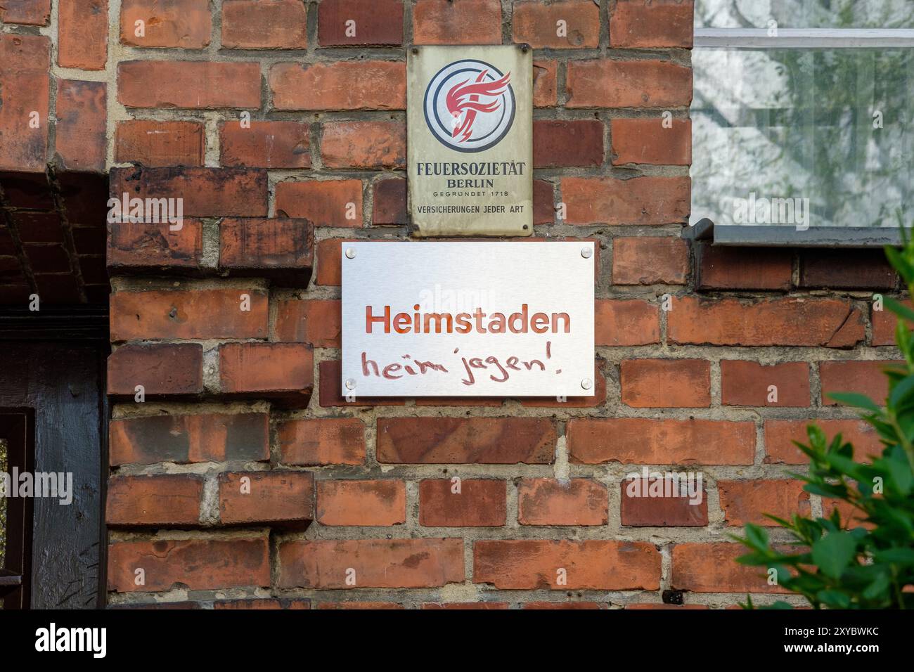 Defaced sign on property owned by controversial corporate landlord Heimstaden says 'Heimstaden heim jagen!' (German for 'Chase Heimstaden home!'). Stock Photo