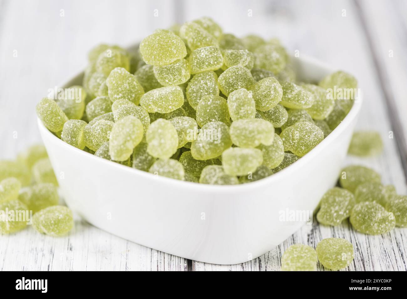 Portion of gummy candy (apple taste) on an old wooden table Stock Photo
