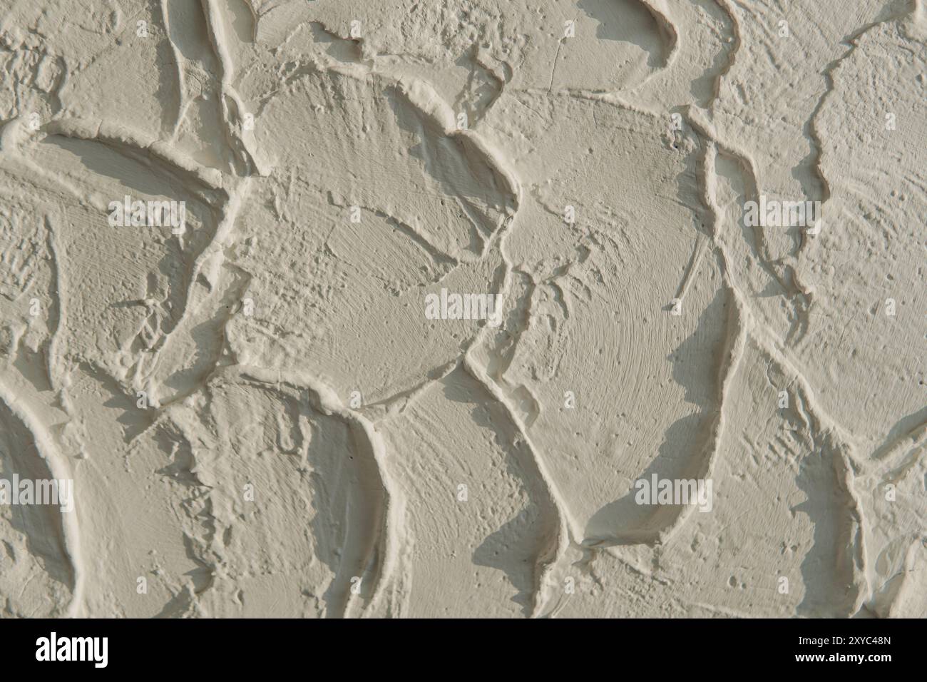 Photography of a wall covered in white paint or cement with a textured ...