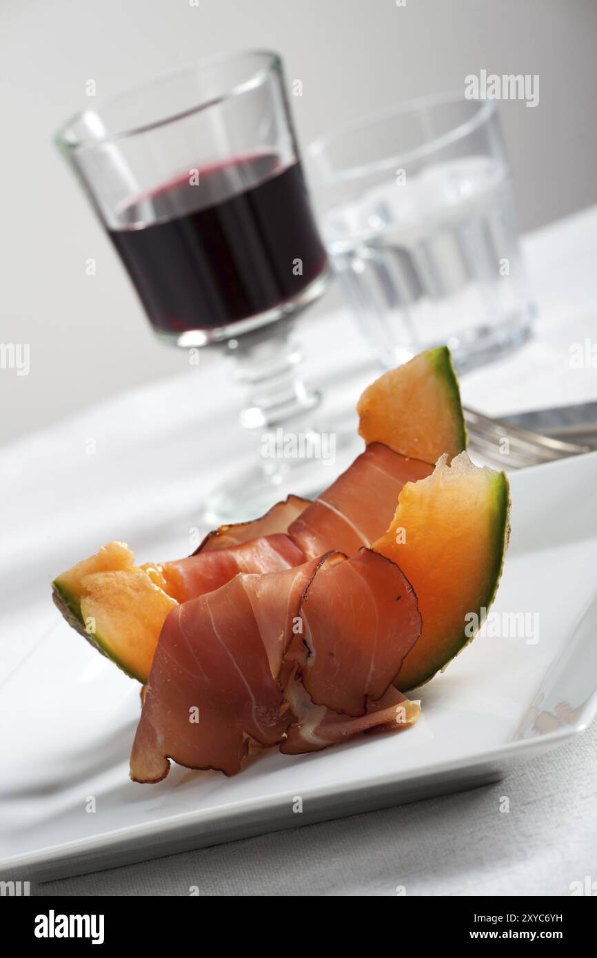 Ham slices and melon with wine Stock Photo