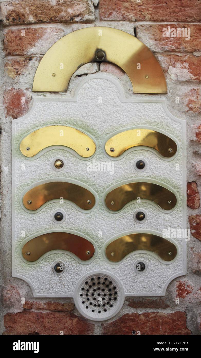 An intercom doorbell panel on the brick wall Stock Photo