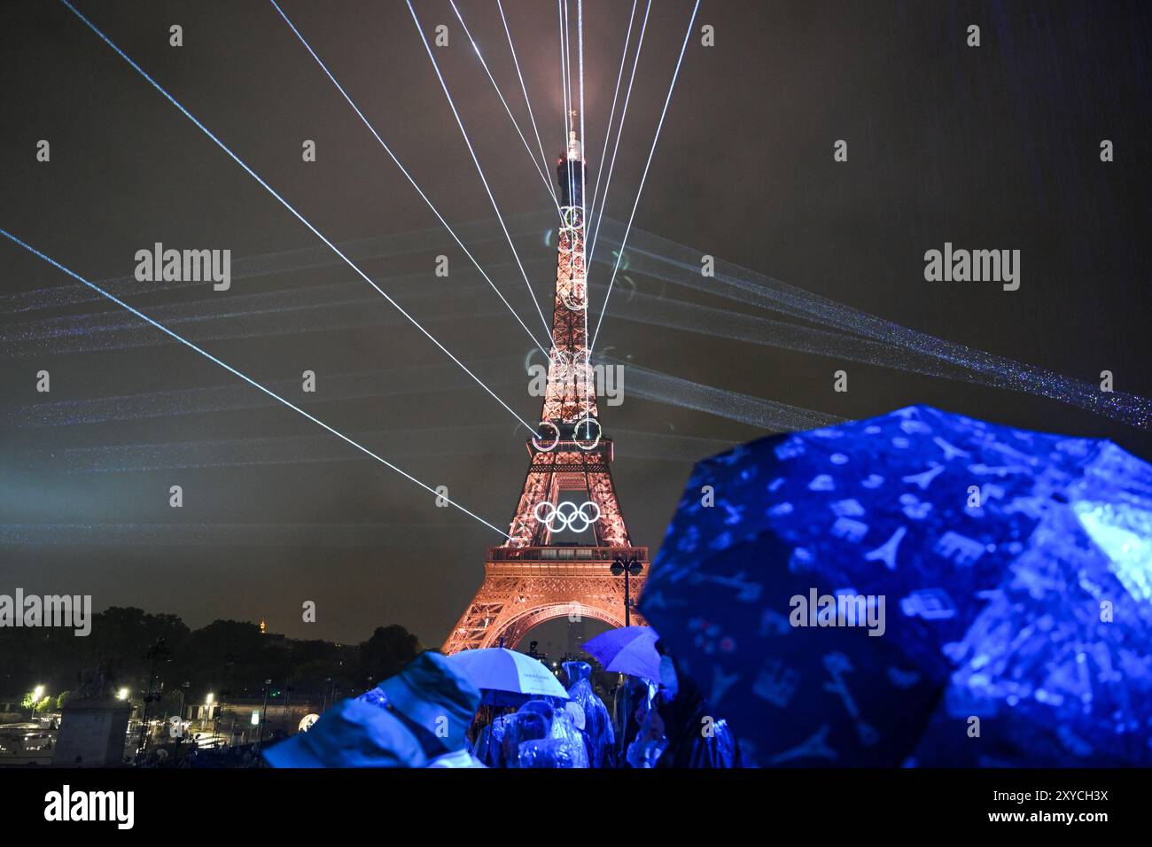 PARIS, FRANCE-26 July 2024: Lights illuminate the Eiffel Tower during the Opening Ceremony of the Olympic Games Paris 2024 Stock Photo