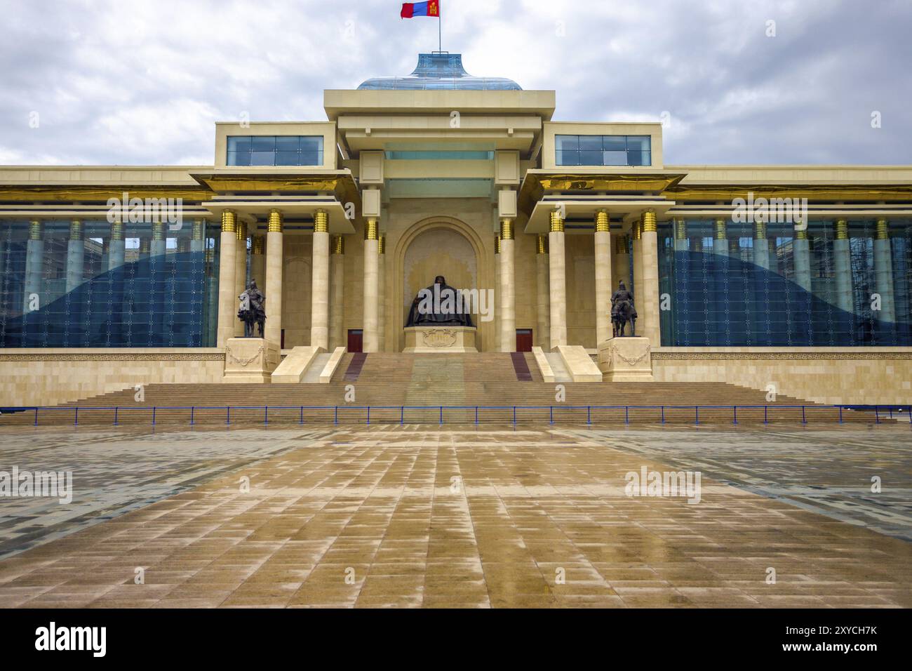 Ghengis Khan statue sits at the center of the Government Palace building on a rainy wet day at Sukhbaatar Square in downtown Ulaanbaatar, Mongolia, As Stock Photo