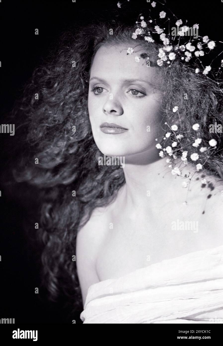 Studio portrait of young woman with curly hair. Stock Photo