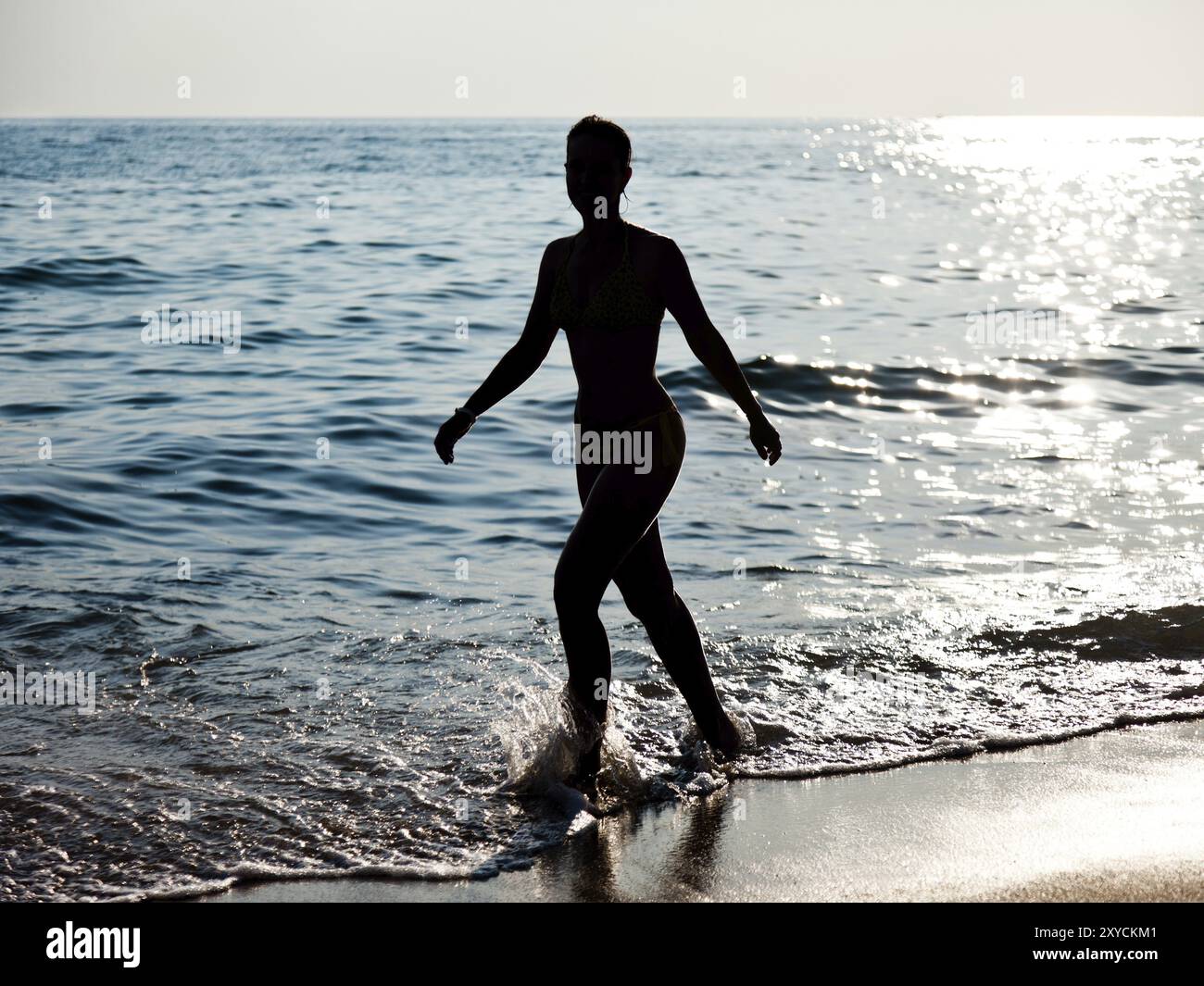 summer-vacations-beautiful-slim-woman-silhouette-walking-on-sea-sand
