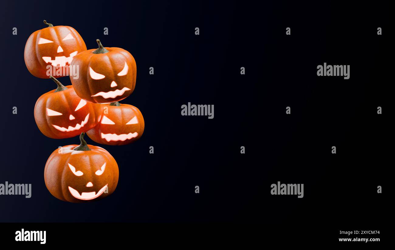 Five illuminated halloween pumpkins with scary faces on a dark blue ...
