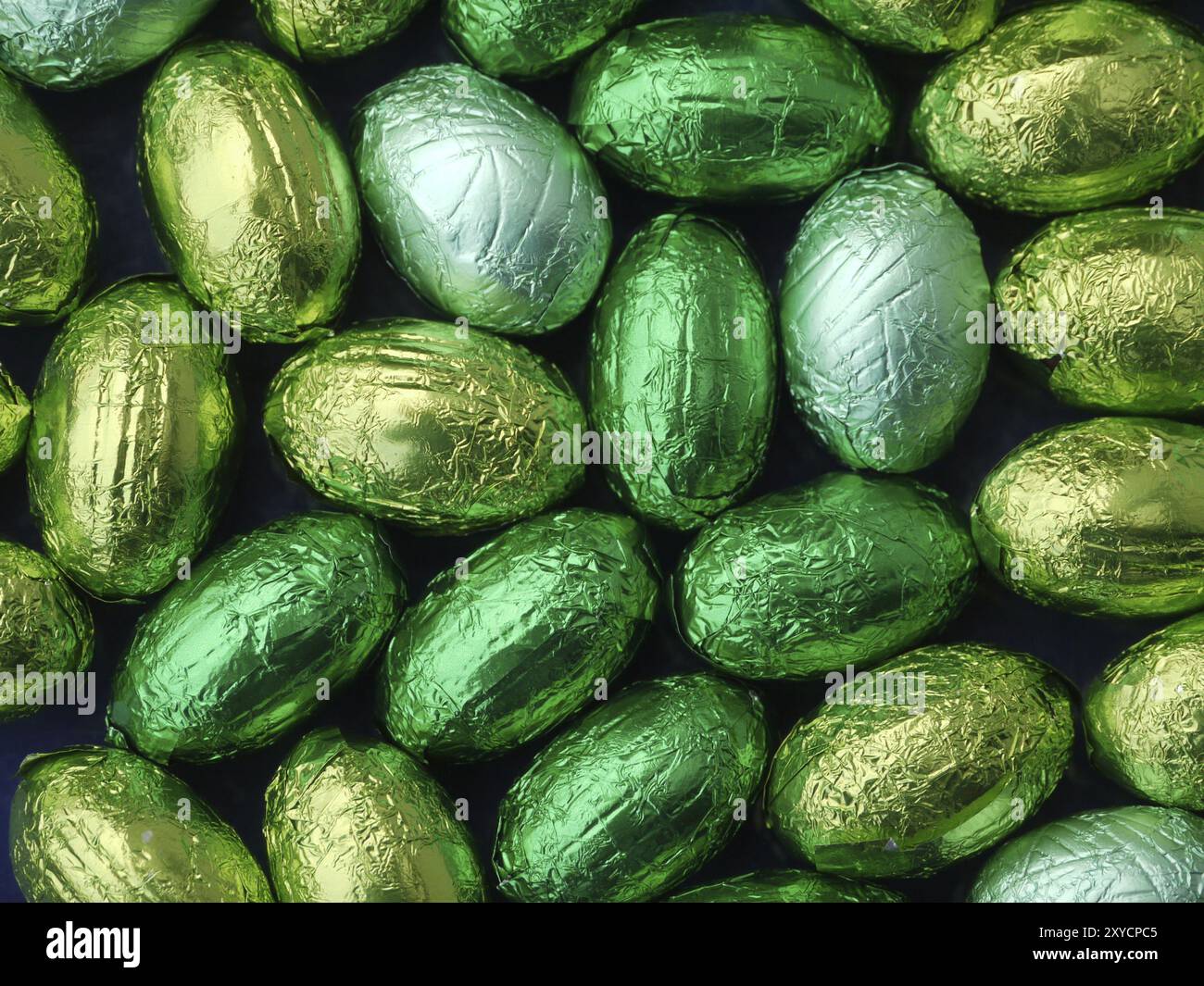 Chocolate eggs in green tin foil Stock Photo